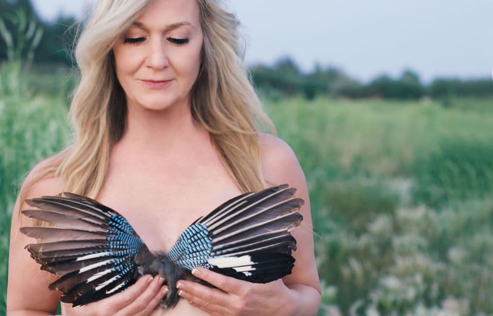 Elayne Le Monde looking at feathers